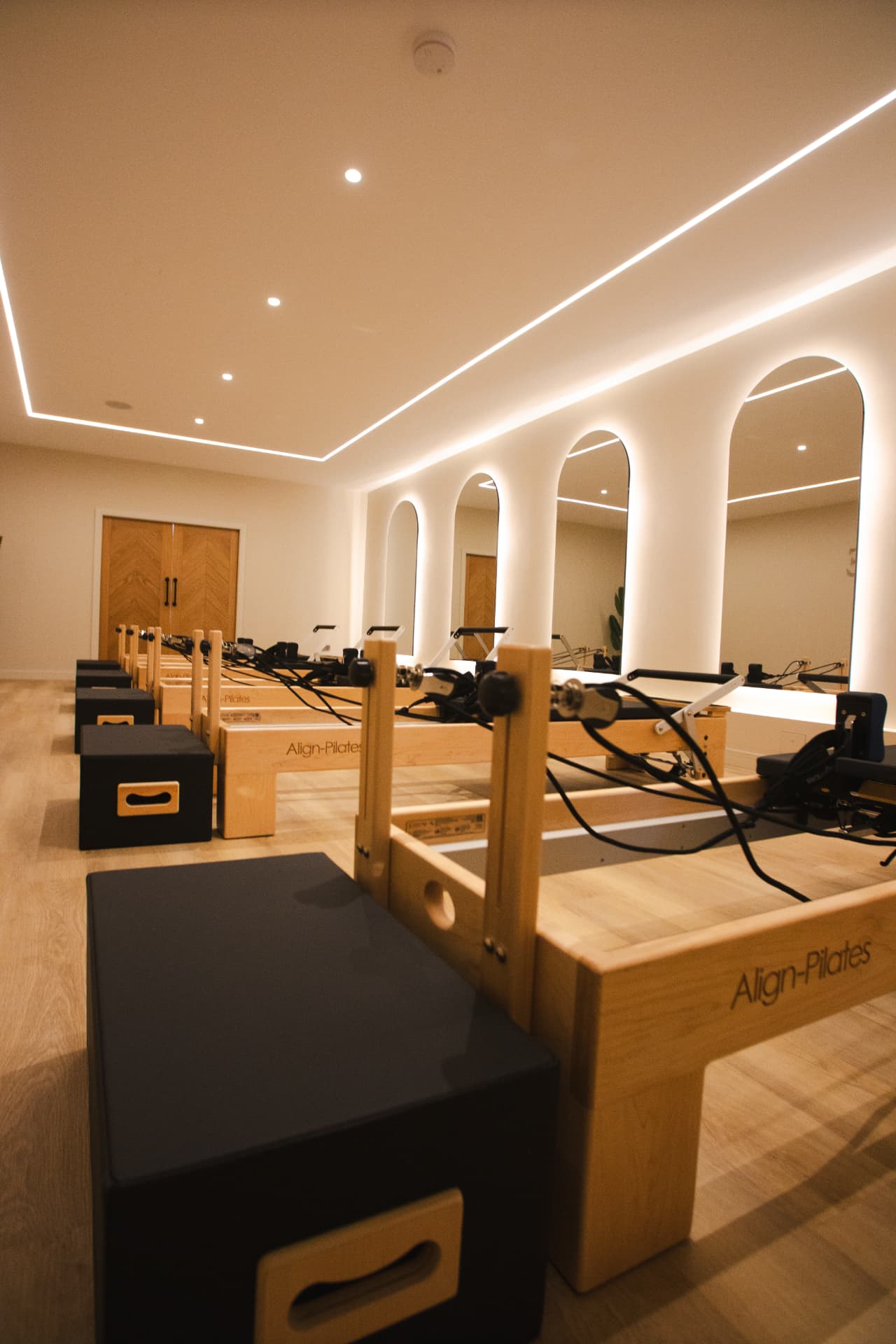 Arched mirrors and Align-Pilates reformers in the FORME studio